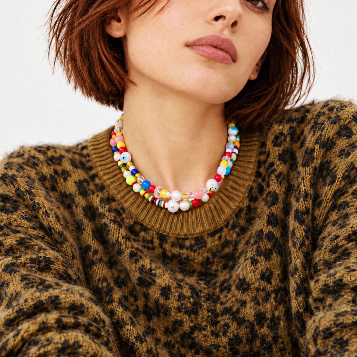 HANAÉ Playful Mix Beaded Necklace featuring colorful mixed beads and freshwater pearls, styled with a brown leopard print sweater for a bold fall and winter look.
